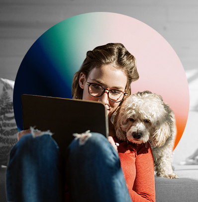 young lady and her dog looking at tablet screen together