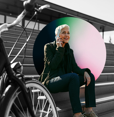 lady sitting in a high school stadium and talking on her phone